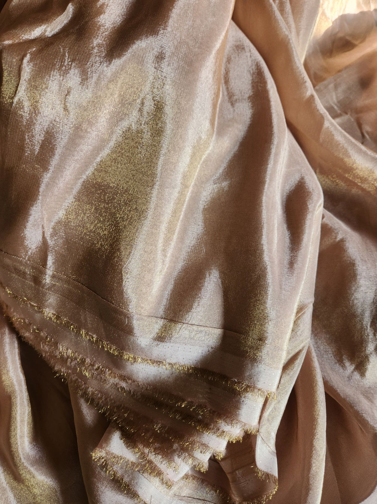 Champagne Gold heavily infused with a golden undertone.
Metallic Shimmer Fabric