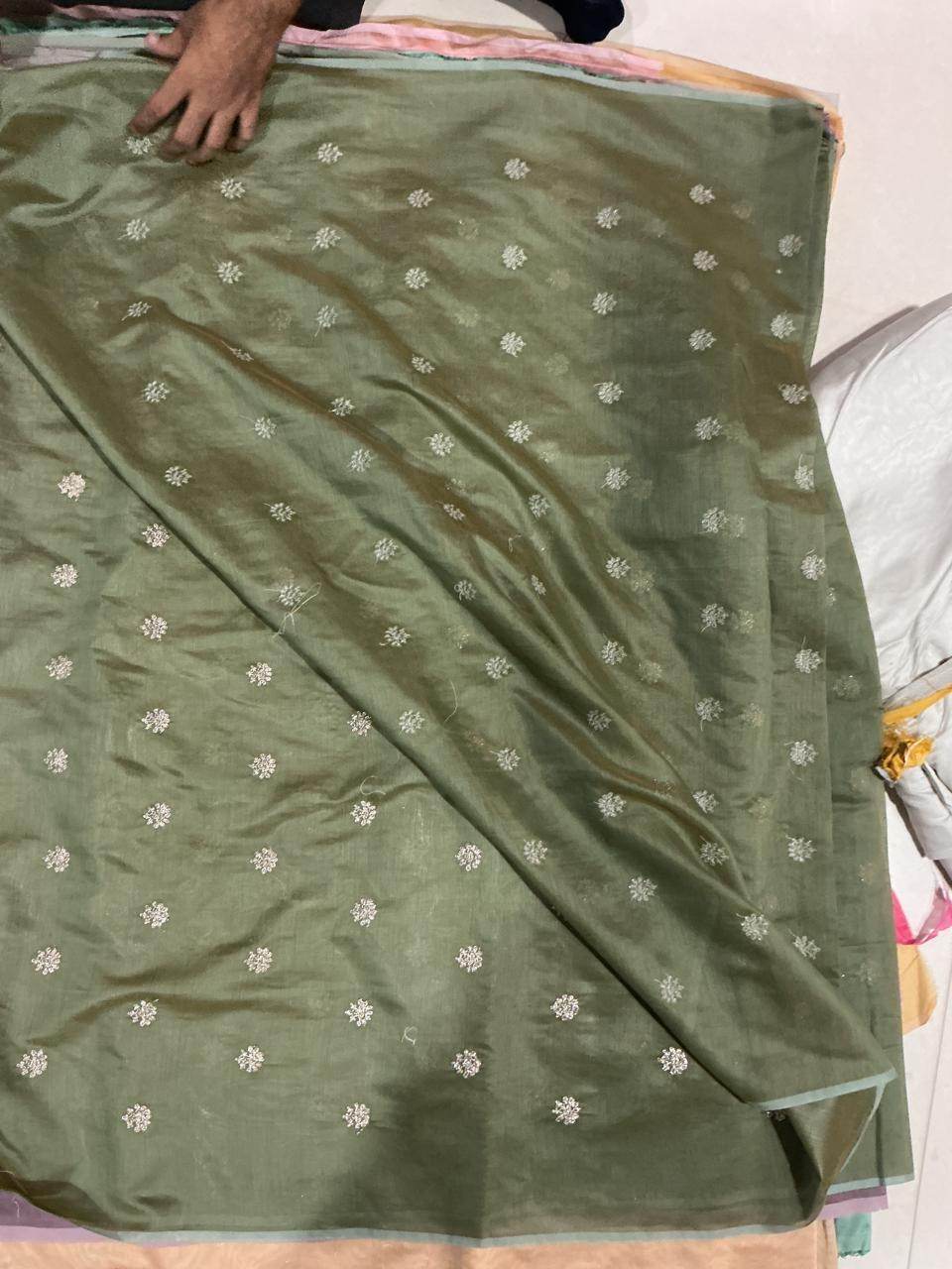 Olive green Chanderi silk fabric with golden glitter motifs draped for saree