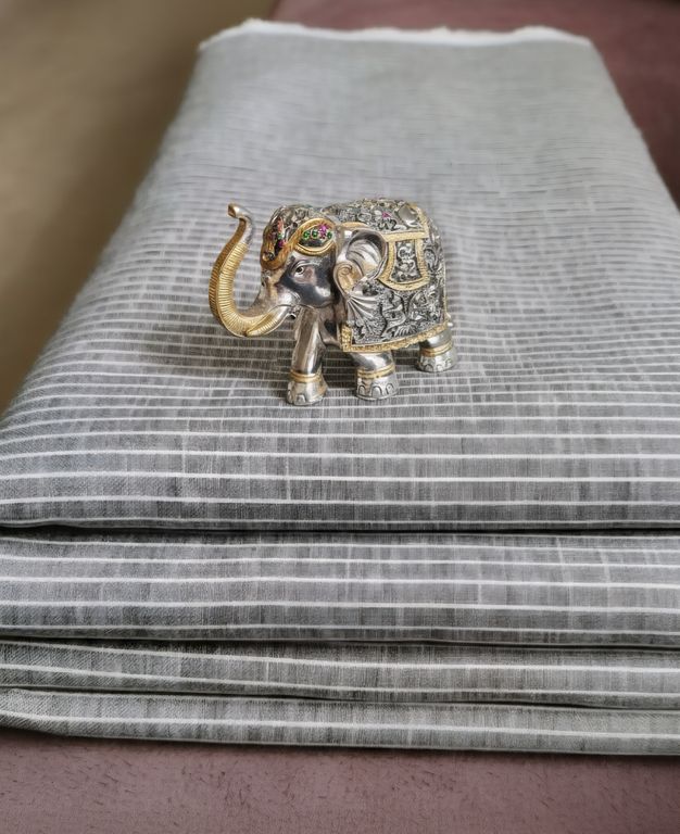 Decorative elephant figurine on a striped fabric surface