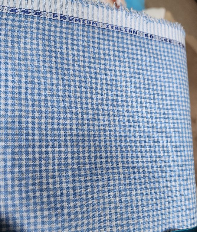 Close-up of blue and white checkered fabric with 'Premium Italian' label.